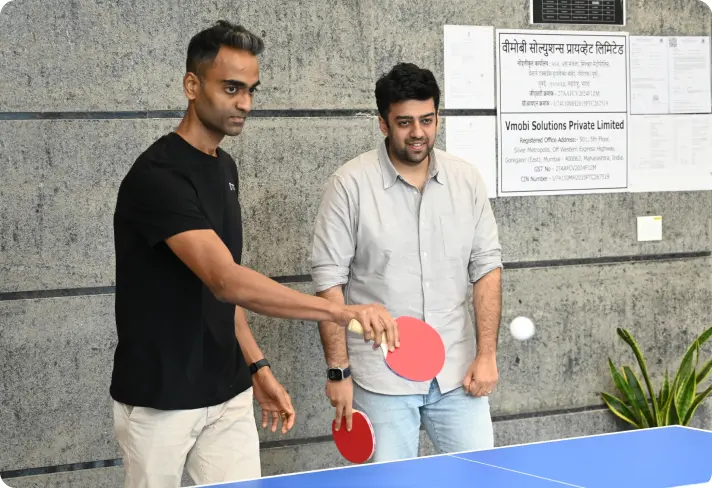 A table tennis rally in the office game room